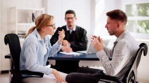 Two people talking to a mediator 